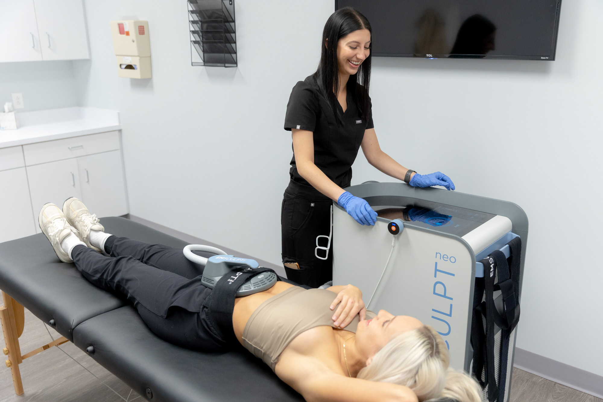 A woman gets an Emsculpt NEO treatment during her appointment for body contouring in Cleveland