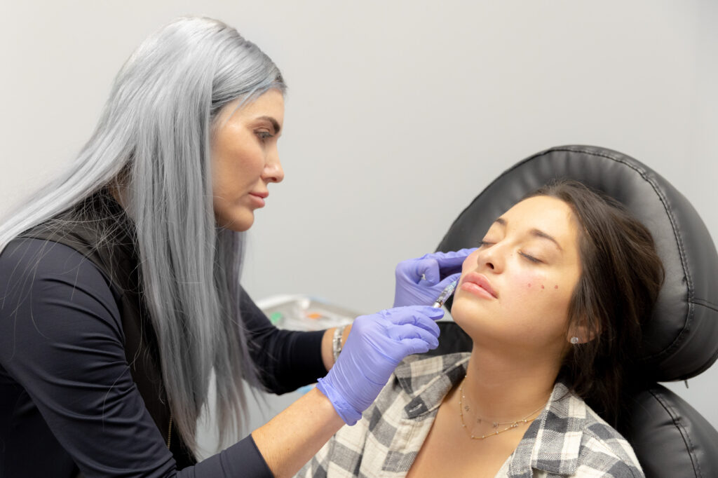 A woman gets a filler injection at Radiant Divine Medical Spa