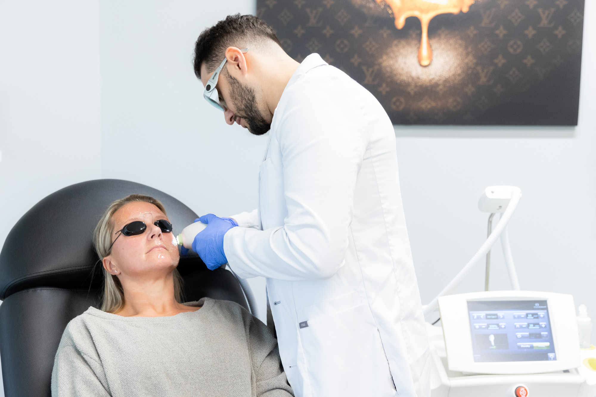 A Radiant Divine provider treats a woman using an IPL laser in Cleveland